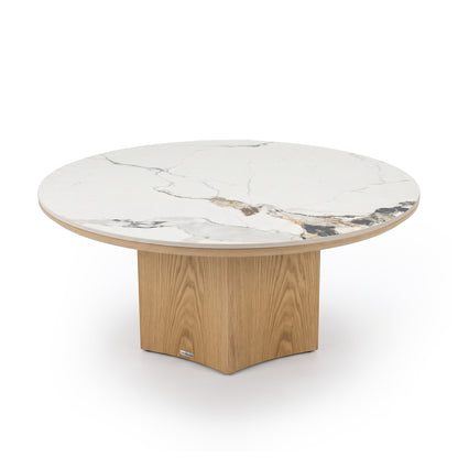 Full view of a round coffee table with marble-look top and wood pedestal base on white background