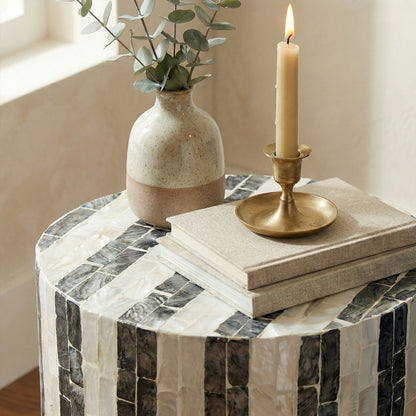 Partial view of mosaic side table with decor items in a living room