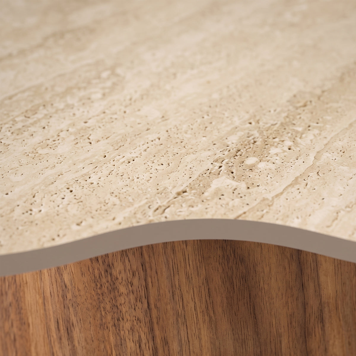 Close-up detail of a stone top meeting a curved wooden edge