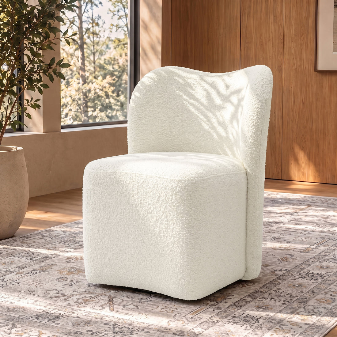 White boucle accent chair in a stylish room with rug and windows