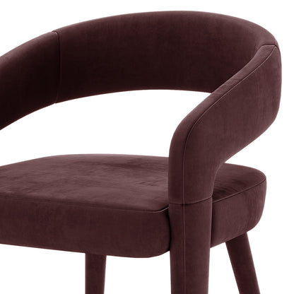 Eisha Velvet Dining Chair Set of 2 in Dark Plum features a modern design with a curved backrest, short arm supports, padded seat, and four tapered legs, all upholstered in luxurious velvet.