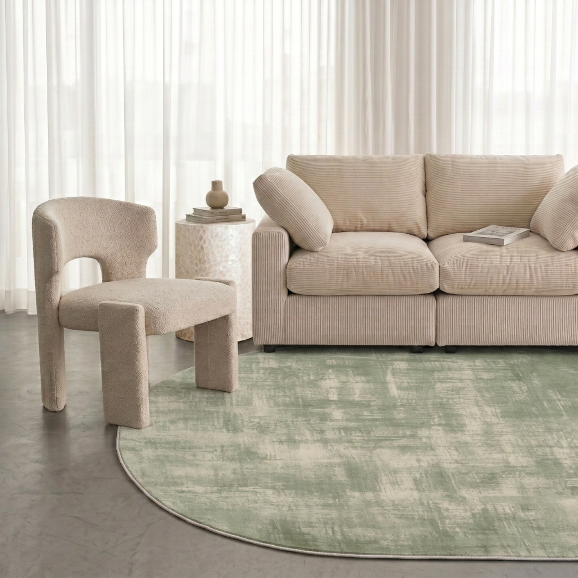 Modern living room with a green patterned rug, sofa, and accent chair