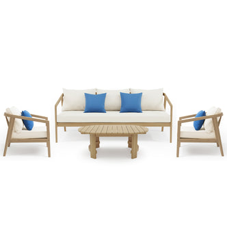 Complete patio furniture set with sofa, armchairs, coffee table and blue accent pillows on white background