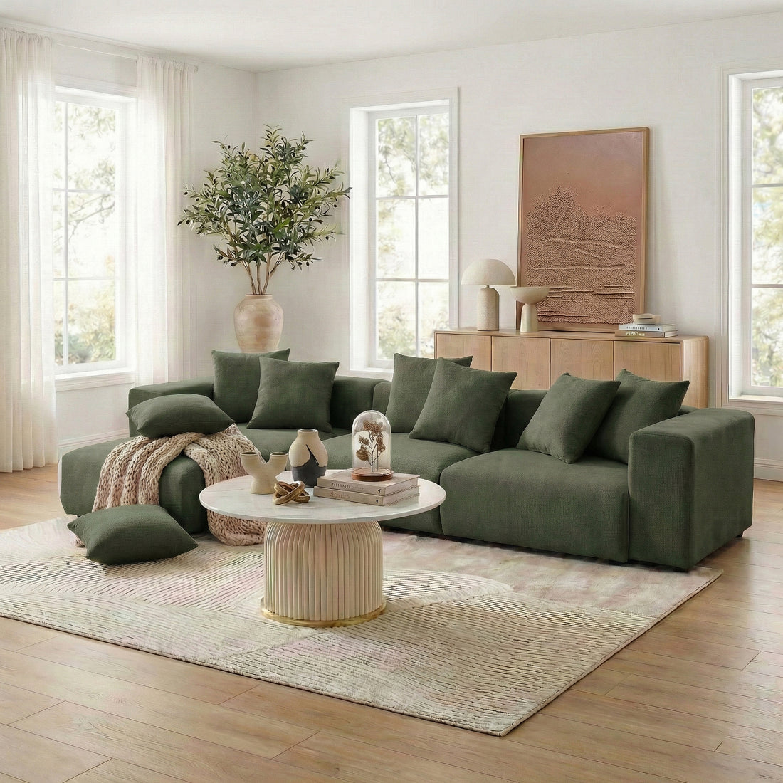 Green sectional sofa in bright living room with coffee table and throw
