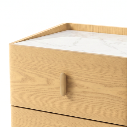 Close-up of the upper section of a light wood nightstand with a marble-look top on a white background