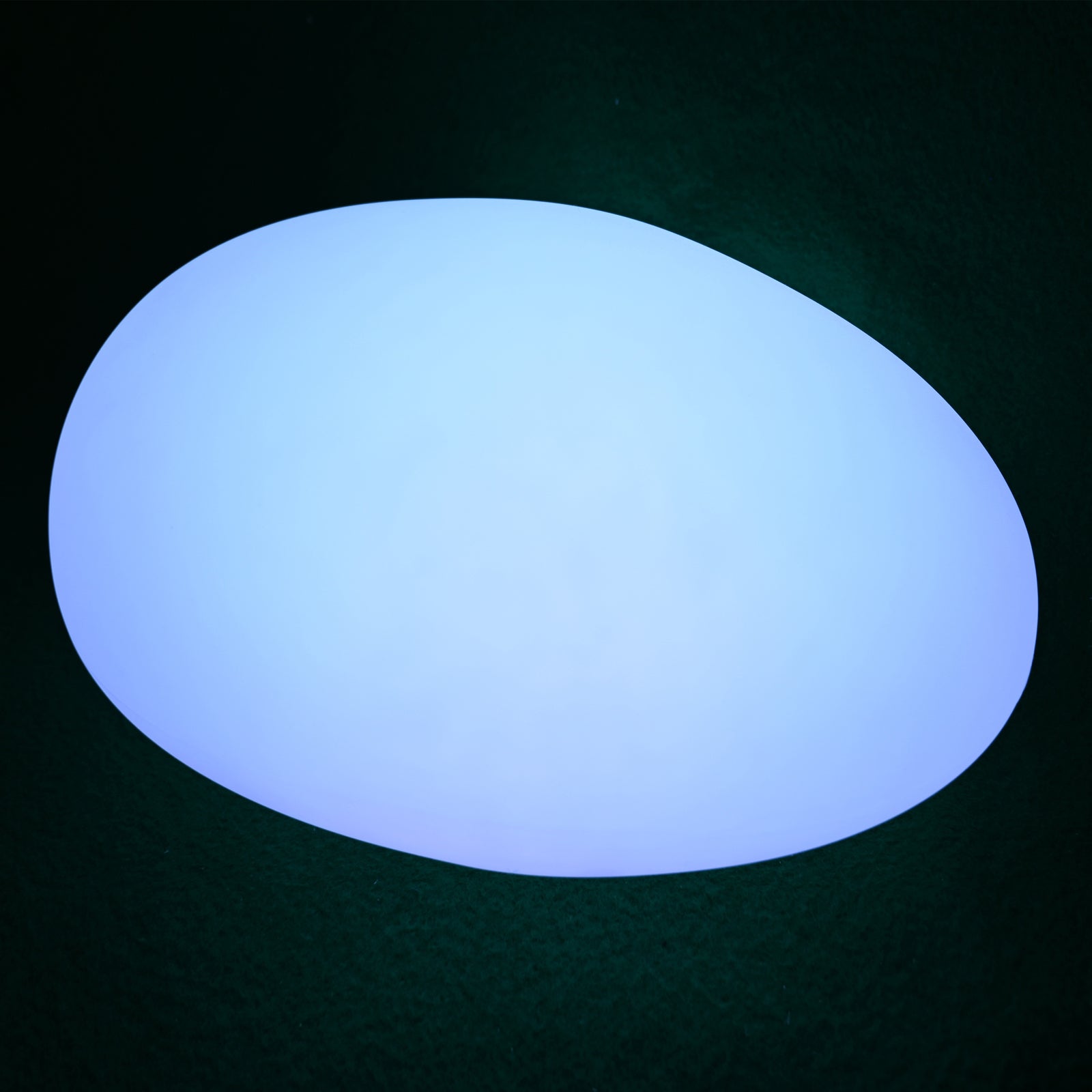 Solar Charging Outdoor LED Rock Light Waterproof Stone Lamp, glowing egg-shaped fixture set against a dark background, simulating a natural stone with integrated LED, perfect for illuminating gardens without wiring.