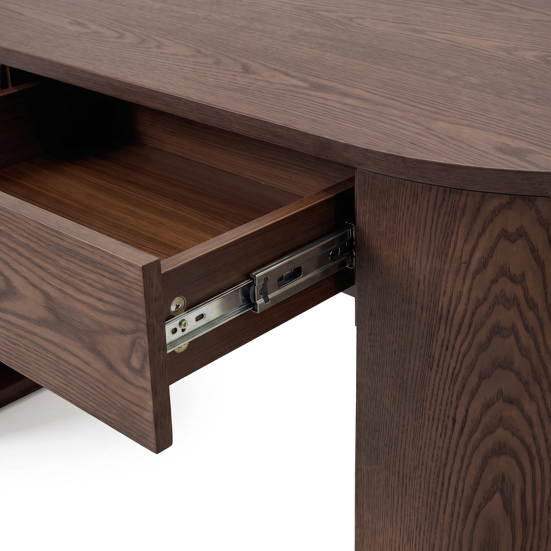 Close-up of an open drawer on a dark wood desk showing the drawer interior and slide hardware