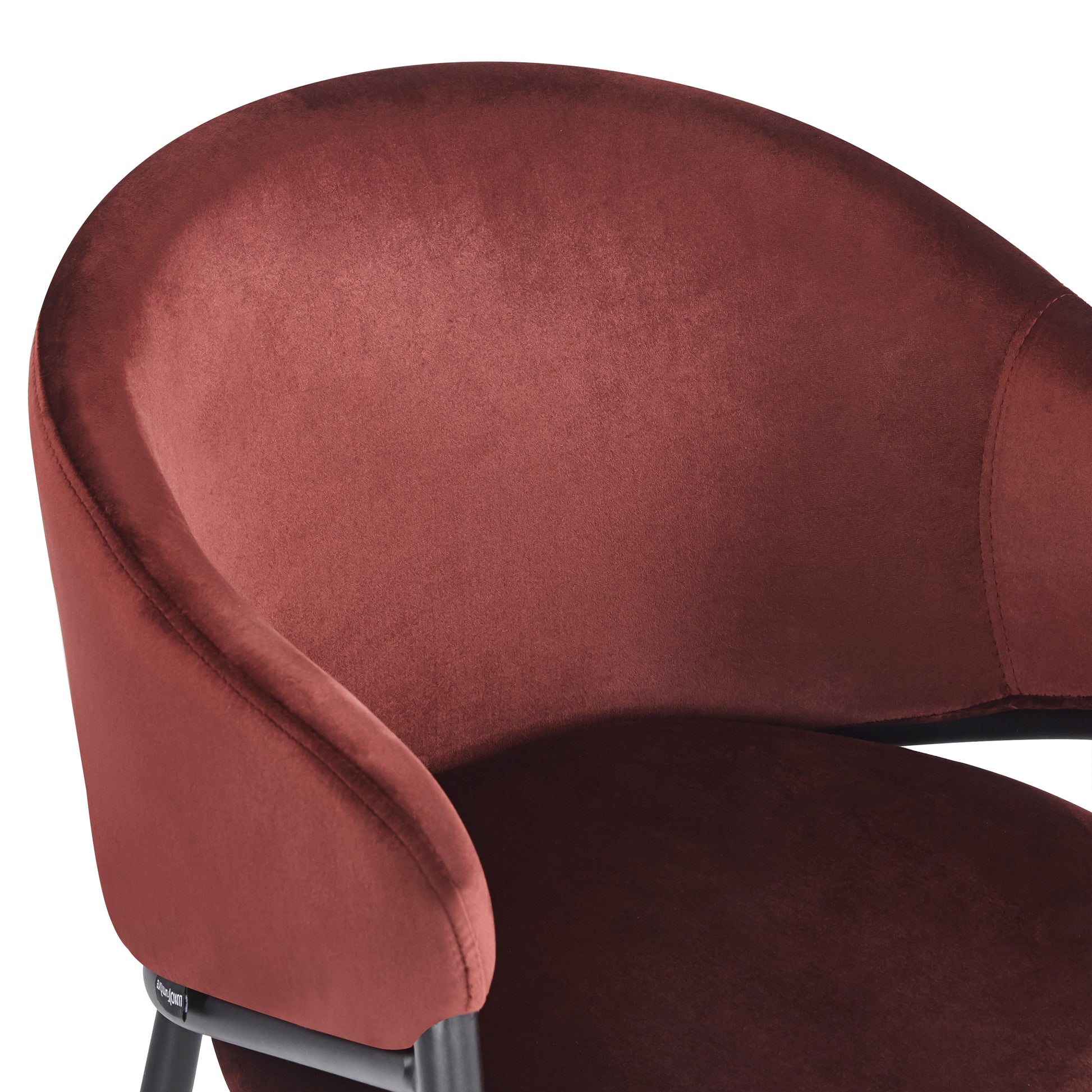 Close-up of burgundy chair’s backrest and seat on white background
