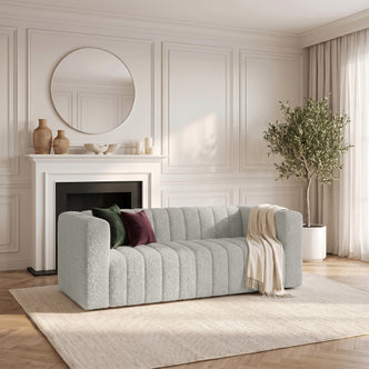 Modern tufted sofa styled in a bright living room