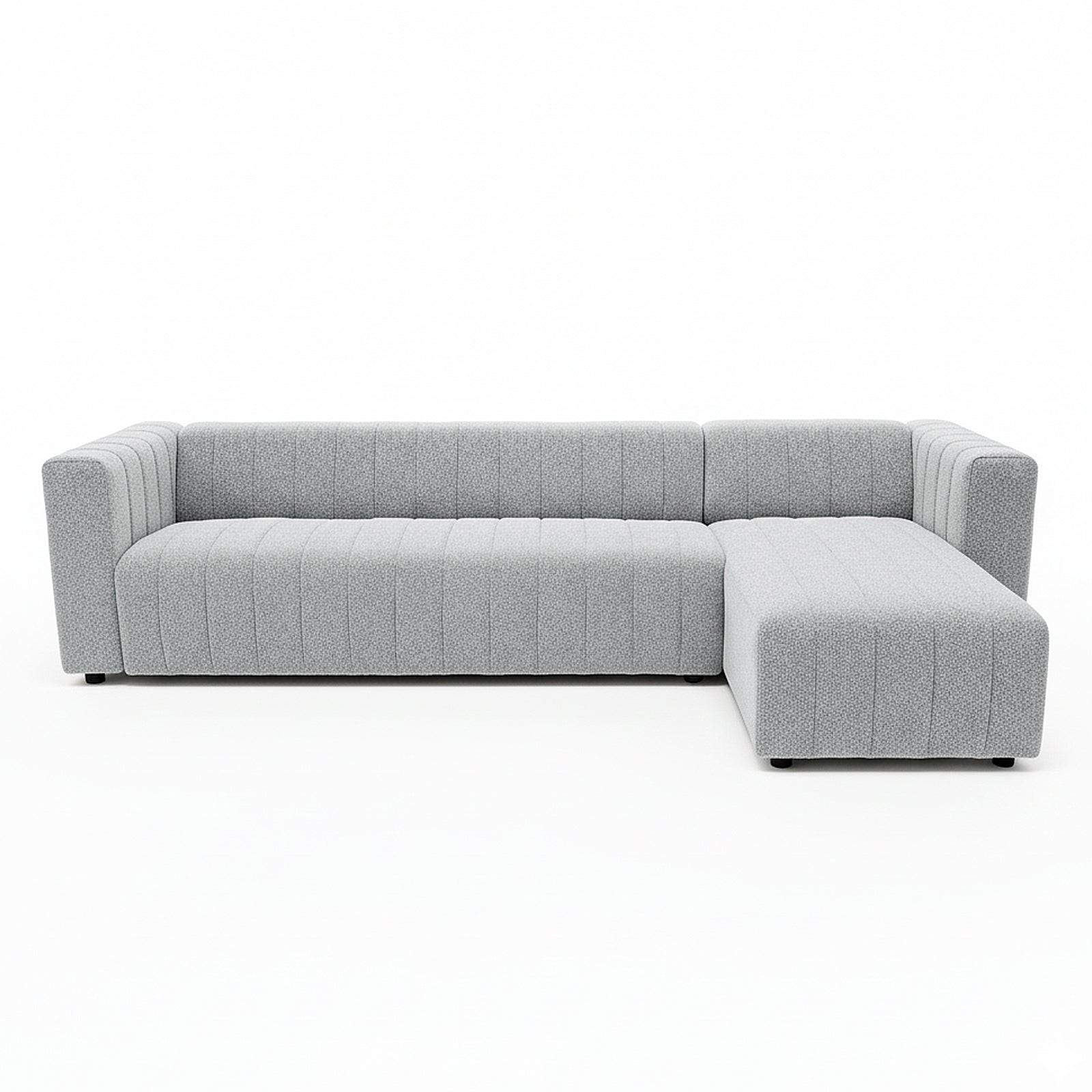 Parisa 4 Seater Tufted Boucle Sofa with Chaise in Light Grey, featuring an L-shape, low wide arms, vertical channel tufting, and a right-hand chaise for relaxed lounging.