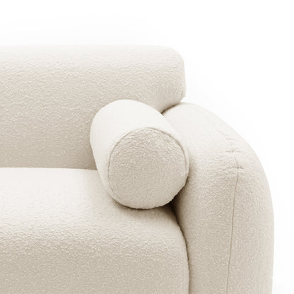 Close-up of off-white upholstered chair armrest and bolster pillow on white background