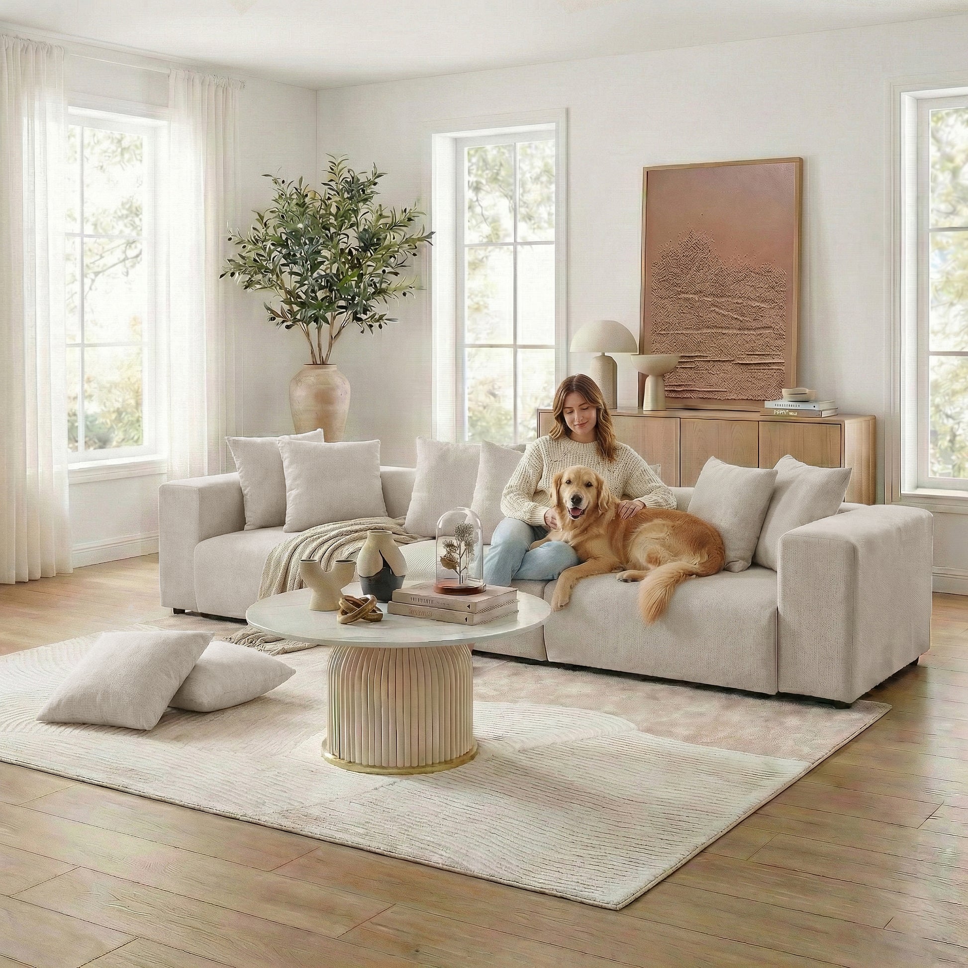 Beige sectional sofa in styled living room with woman and dog