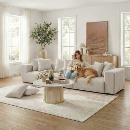 Beige sectional sofa in styled living room with woman and dog