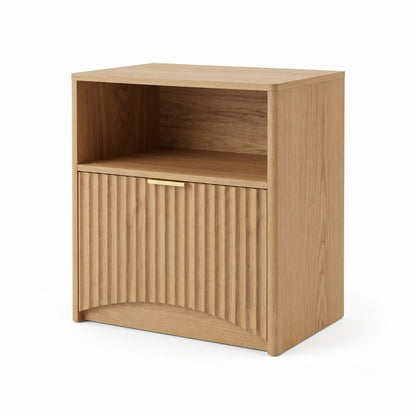 Natural wood nightstand with open shelf and fluted lower door on a white background.