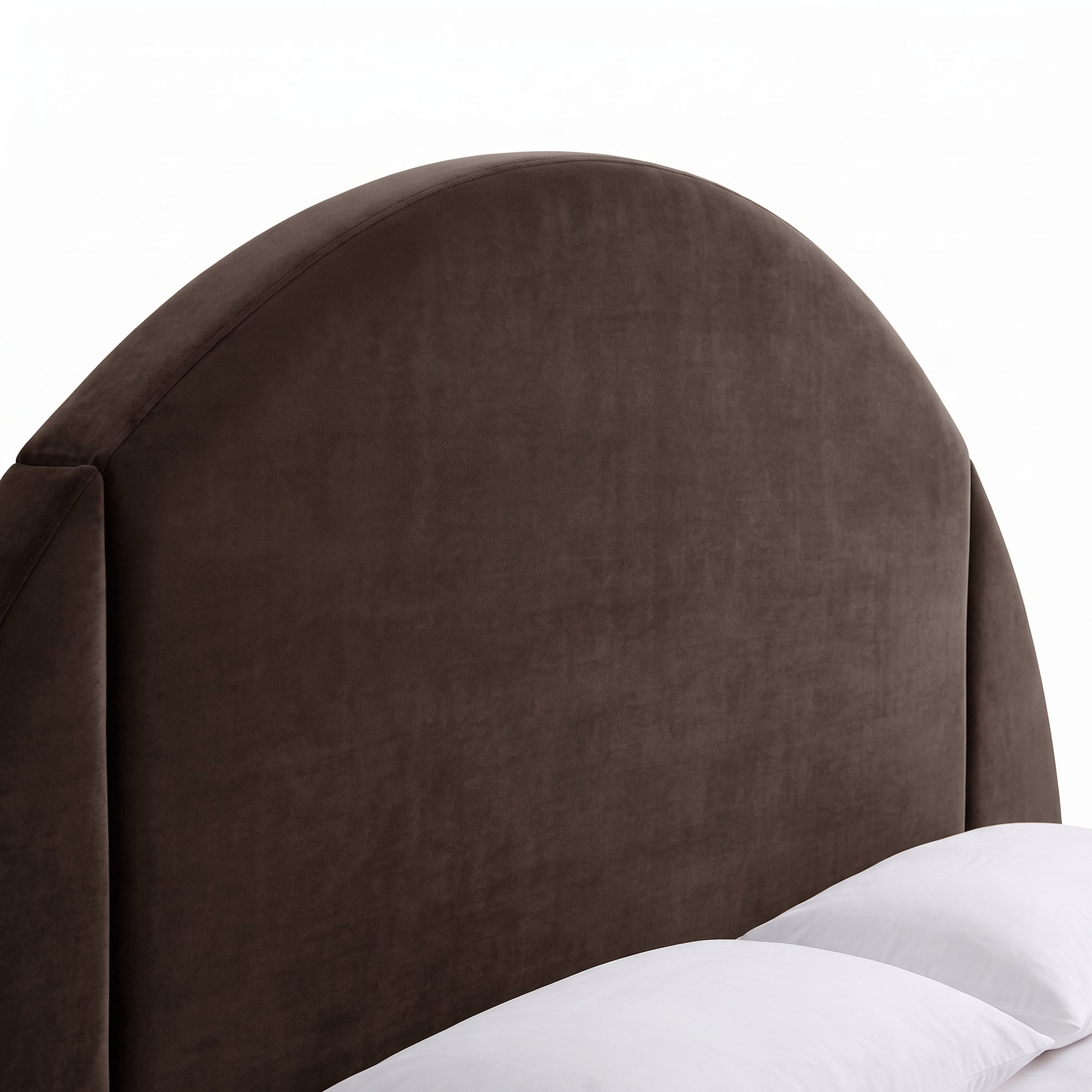 Close-up of a dark upholstered semicircular headboard on a white background
