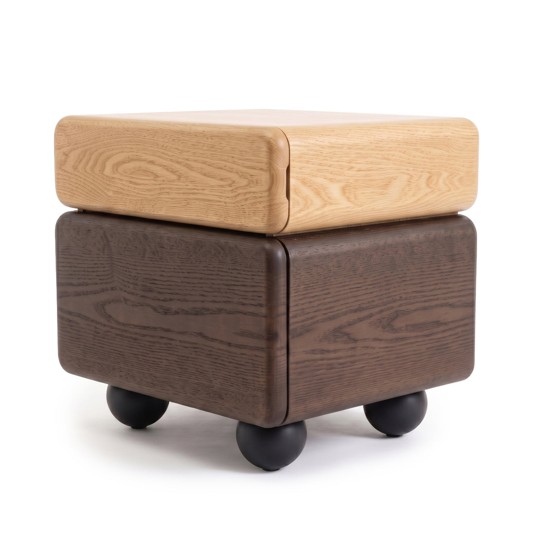Cube-shaped two-tone wooden side table with black spherical feet on a white background