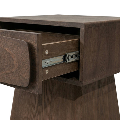 Close view of a wooden nightstand with an open drawer on white background