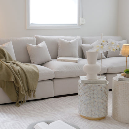 Light gray sectional sofa styled with decor in a modern living room