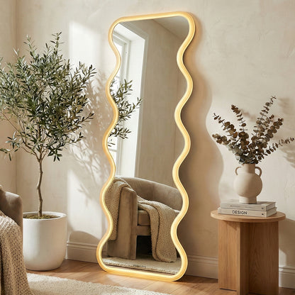 Wavy LED mirror leaning against a wall in a styled living room with plants and decor