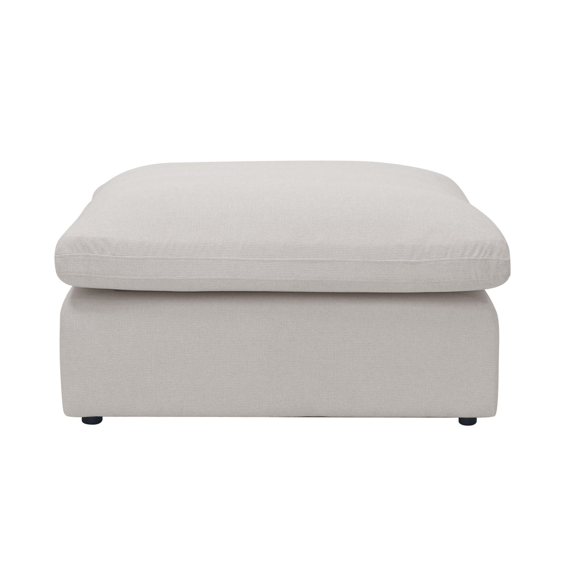 Light beige upholstered ottoman photographed on a white background