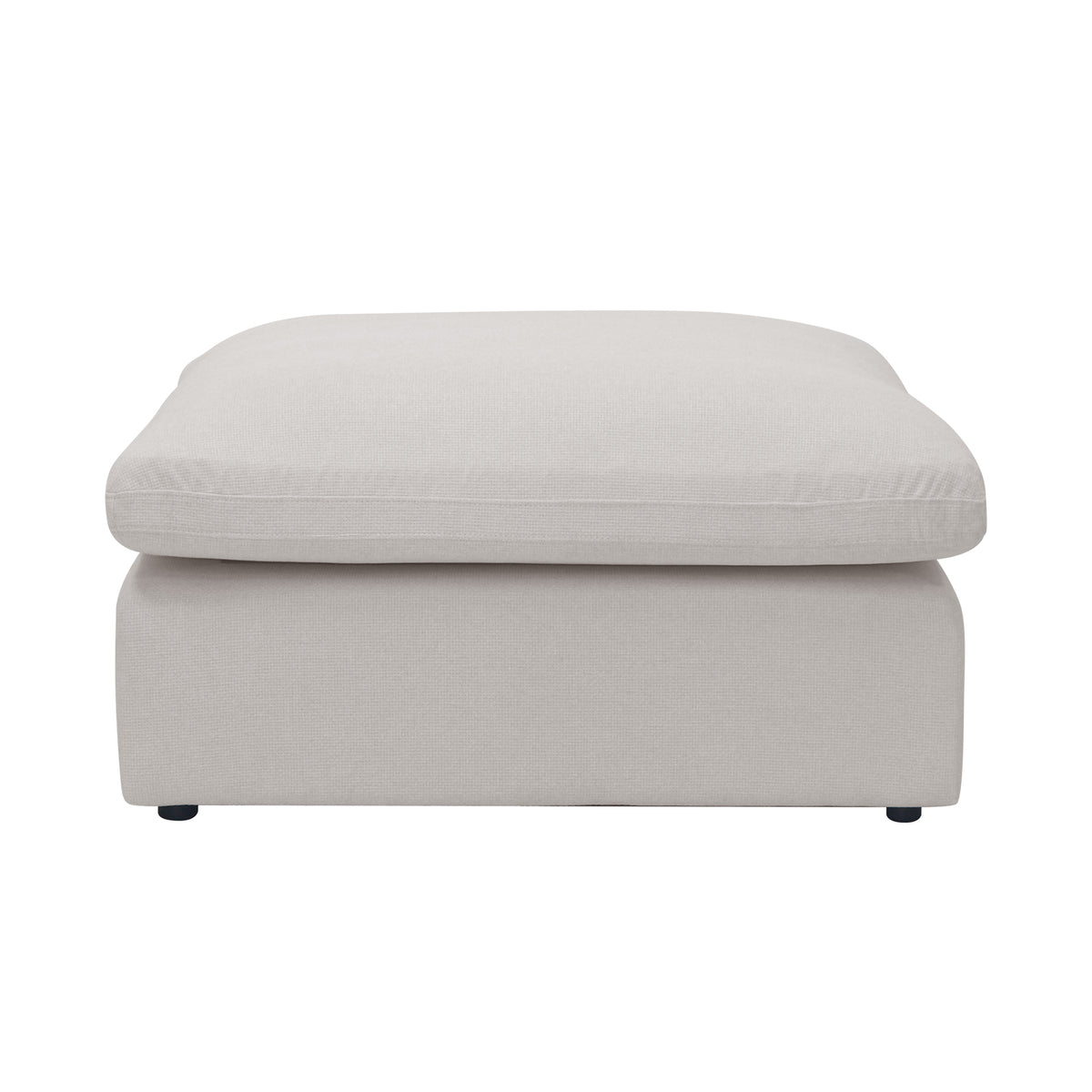 Light beige upholstered ottoman photographed on a white background