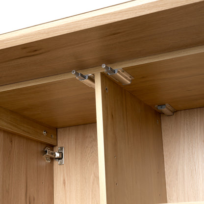 Close-up of internal wooden furniture structure with metal hardware and joinery
