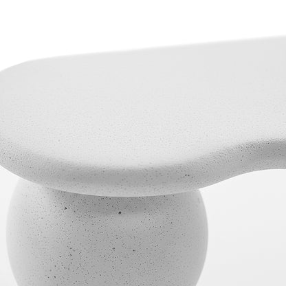 Close-up of white table edge and rounded leg showing texture