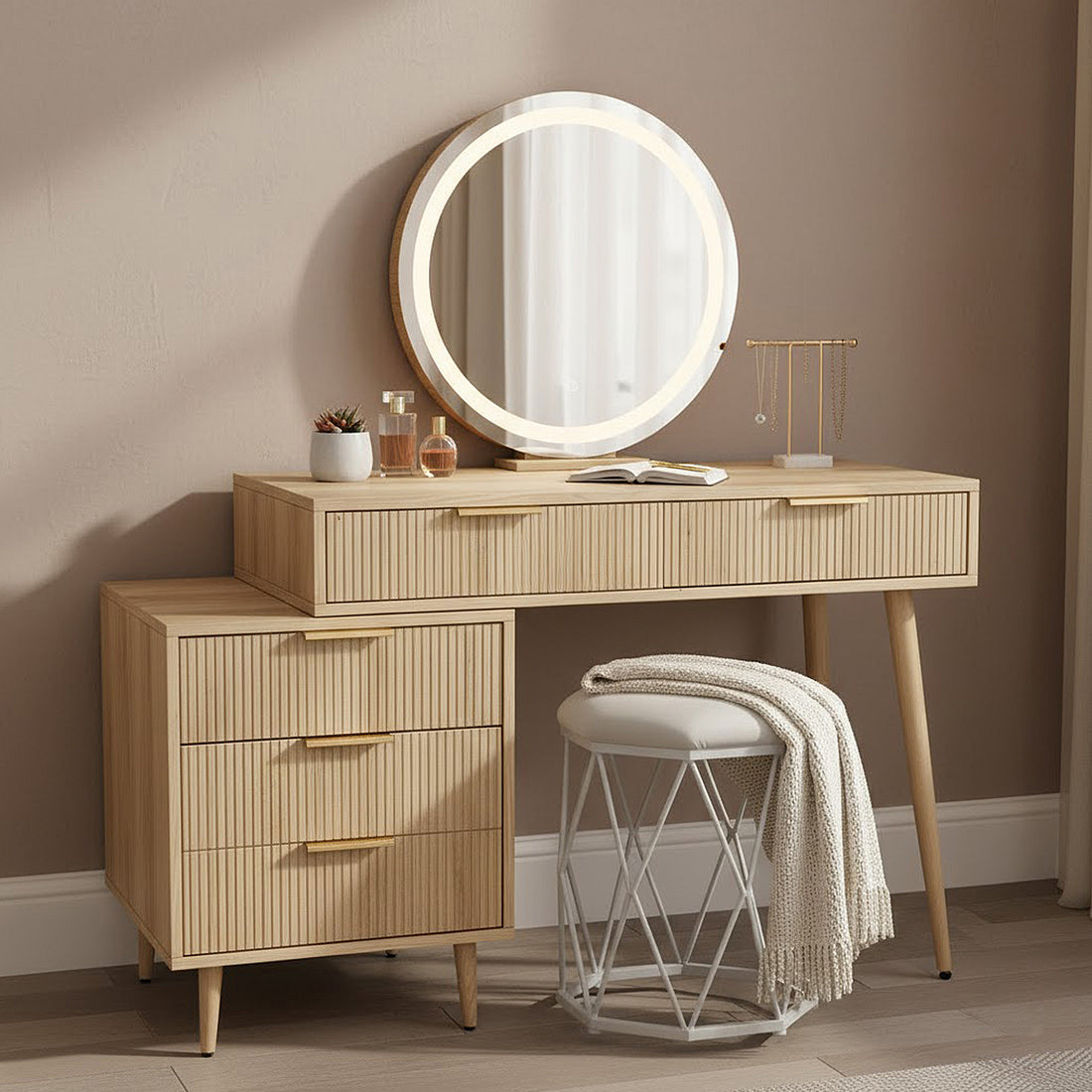 Serenity Dressing Table with Touch Screen Mirror in Natural features a two-tiered wooden vanity, round LED mirror, ribbed-front drawers, T-bar jewelry stand, and white stool with a knit throw.