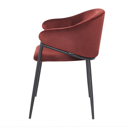 Side profile of burgundy velvet chair on white background