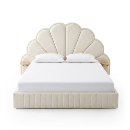 Full view of upholstered bed with scalloped headboard on white background