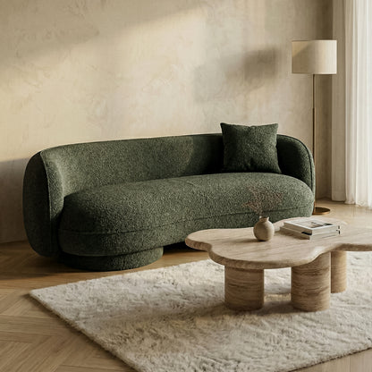 Dark green sofa in modern living room setting with wooden coffee table
