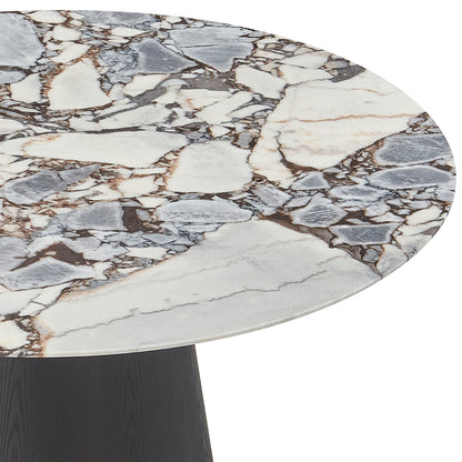 Dina 120cm Round Marble Dining Table features a richly veined marble top with gray and brown patterns, set on a dark, tapered pedestal base, embodying elegance and compact design.