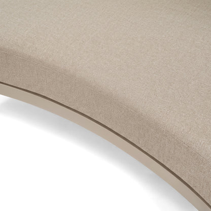 Close-up of curved beige upholstered furniture on a white background