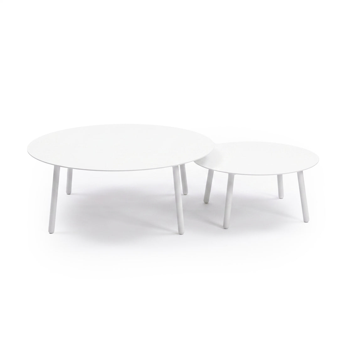 Two round white nesting tables on a white background