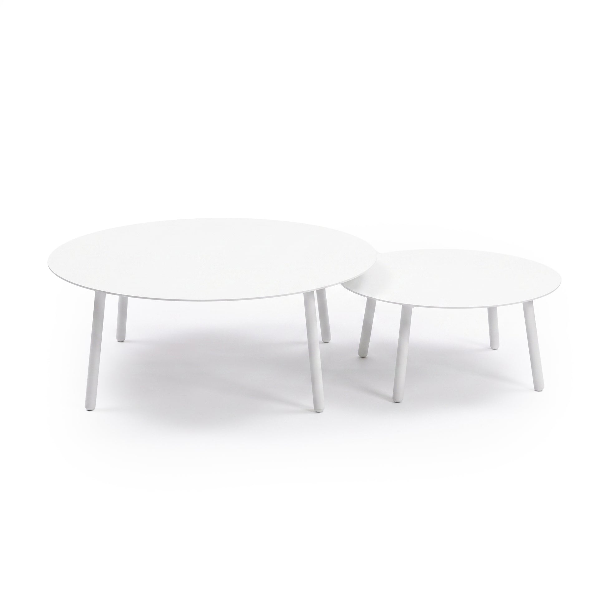 Two round white nesting tables on a white background