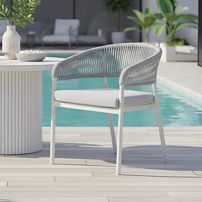 Coastal Outdoor Rope Dining Chairs Set of 2 in White, featuring a modern design with slender metal legs and a woven gray rope back, elegantly placed poolside next to a slatted-side table.