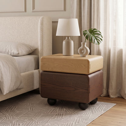 Modern two-tone wooden nightstand styled beside a bed in a cozy bedroom