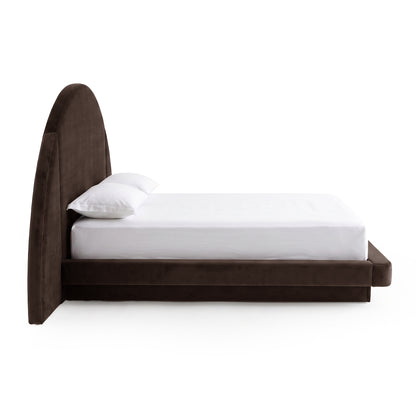 Side view of a modern upholstered bed on a white background