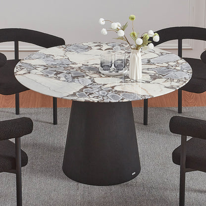 Dina 120cm Round Marble Dining Table in Blue Galaxy Black, featuring a white-and-gray marble top and a solid black pedestal base, surrounded by four black chairs on a neutral rug.