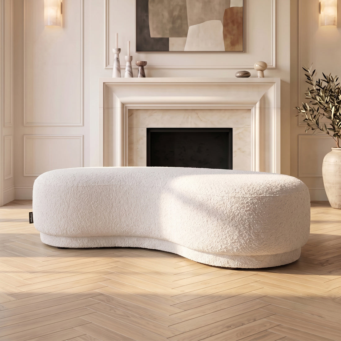 Curved cream white upholstered bench seat in a stylish living room