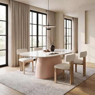Modern oval dining table styled in a contemporary dining room with chairs and decor