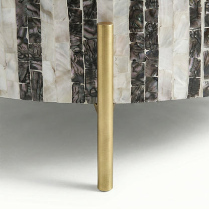 Close-up of shell-inlay detail and gold/brass leg on white background