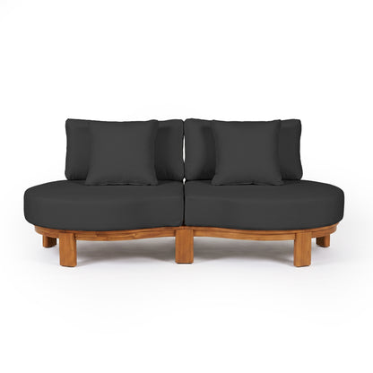 Modern curved sofa with black cushions and wooden base on white background