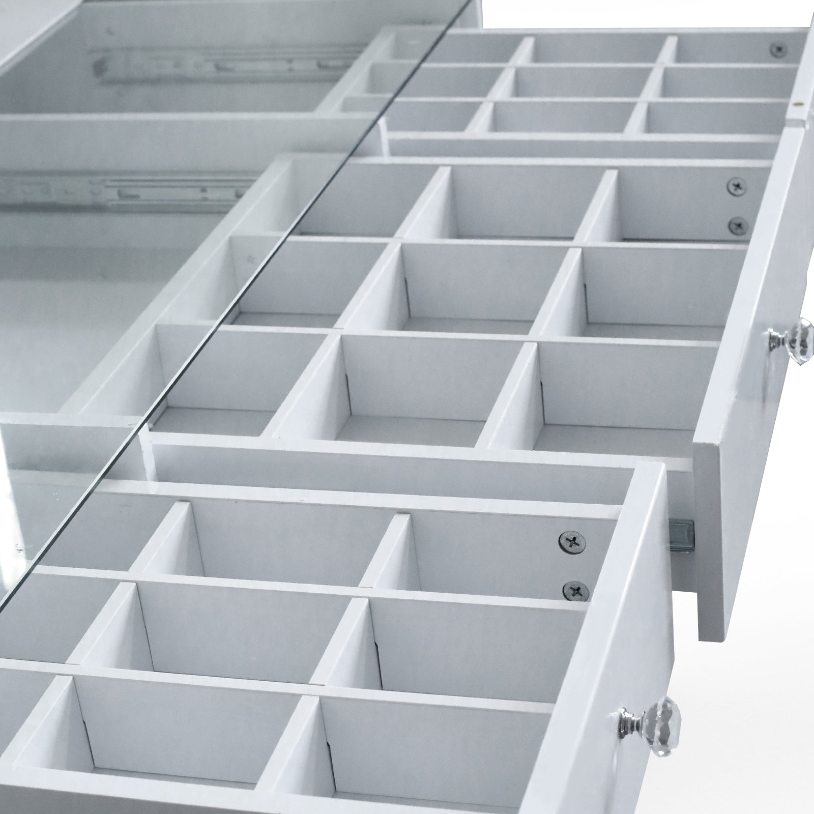 Close-up of vanity drawers and compartments on white background