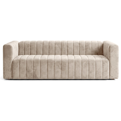 Beige channel-tufted sofa on a white background