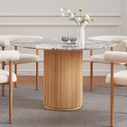 Gracie 120cm Round Marble Dining Table in Natural, showcasing a white-and-gray veined marble top on a fluted wood base, surrounded by cream boucle chairs with wooden accents in a minimalist dining setup.
