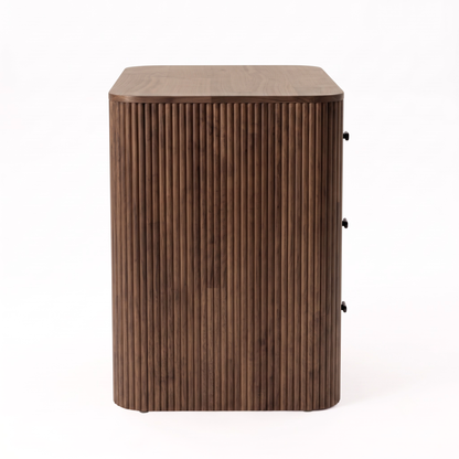 Side view of a wooden cabinet with vertical slat detailing on a white background