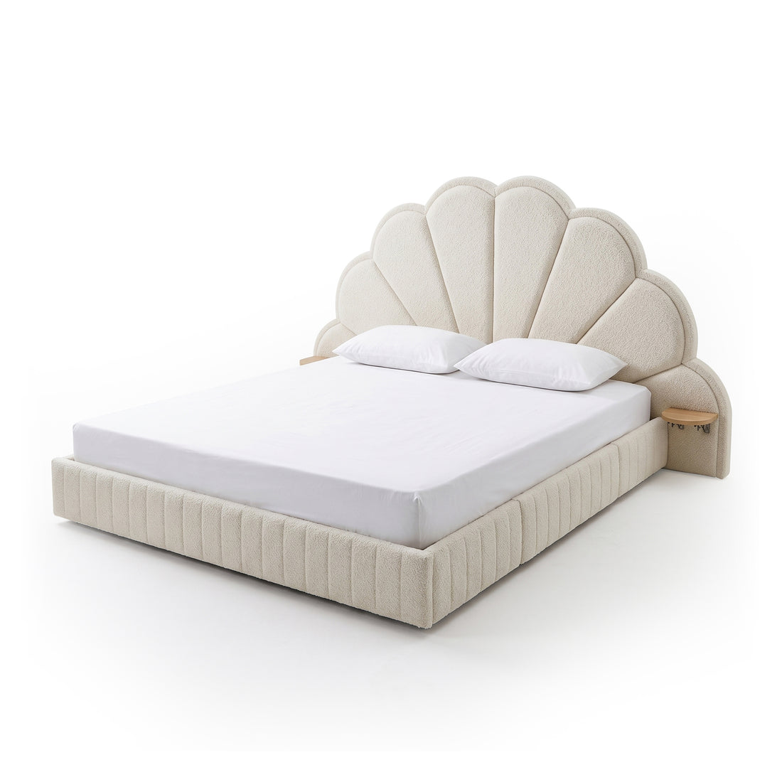 Upholstered bed with scalloped headboard on white background