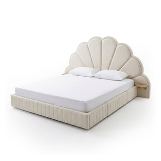 Upholstered bed with scalloped headboard on white background