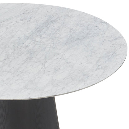 Dina 120cm Round Marble Dining Table in Carrara Black, showcasing its elegant white marble top with light gray veins and the top edge of a dark, conical wooden pedestal base.